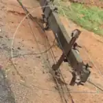 A damaged electric pole lies on a road in Hyderabad's Cyber City