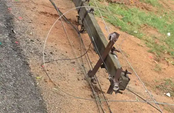 A damaged electric pole lies on a road in Hyderabad's Cyber City